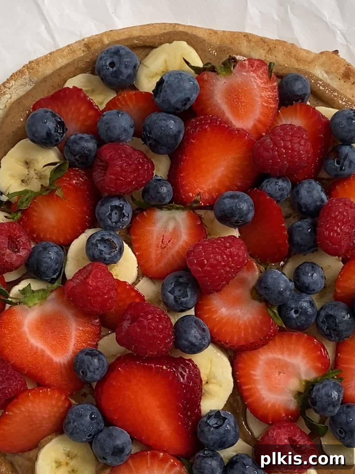 Sunshine Fruit Pizza 11 process of adding raspberries to fruit pizza