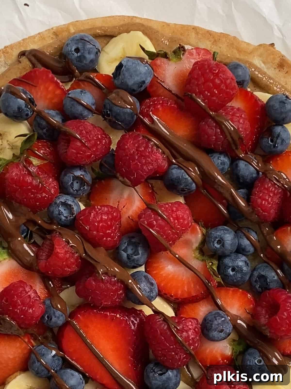 Sunshine Fruit Pizza 12 process of adding vegan chocolate drizzle to fruit pizza