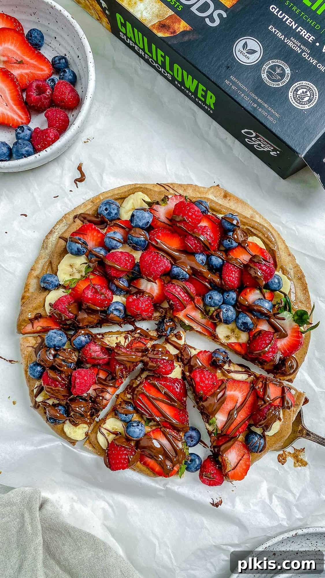 Sunshine Fruit Pizza 13 completed fruit pizza with one slice slightly shifted against a white background