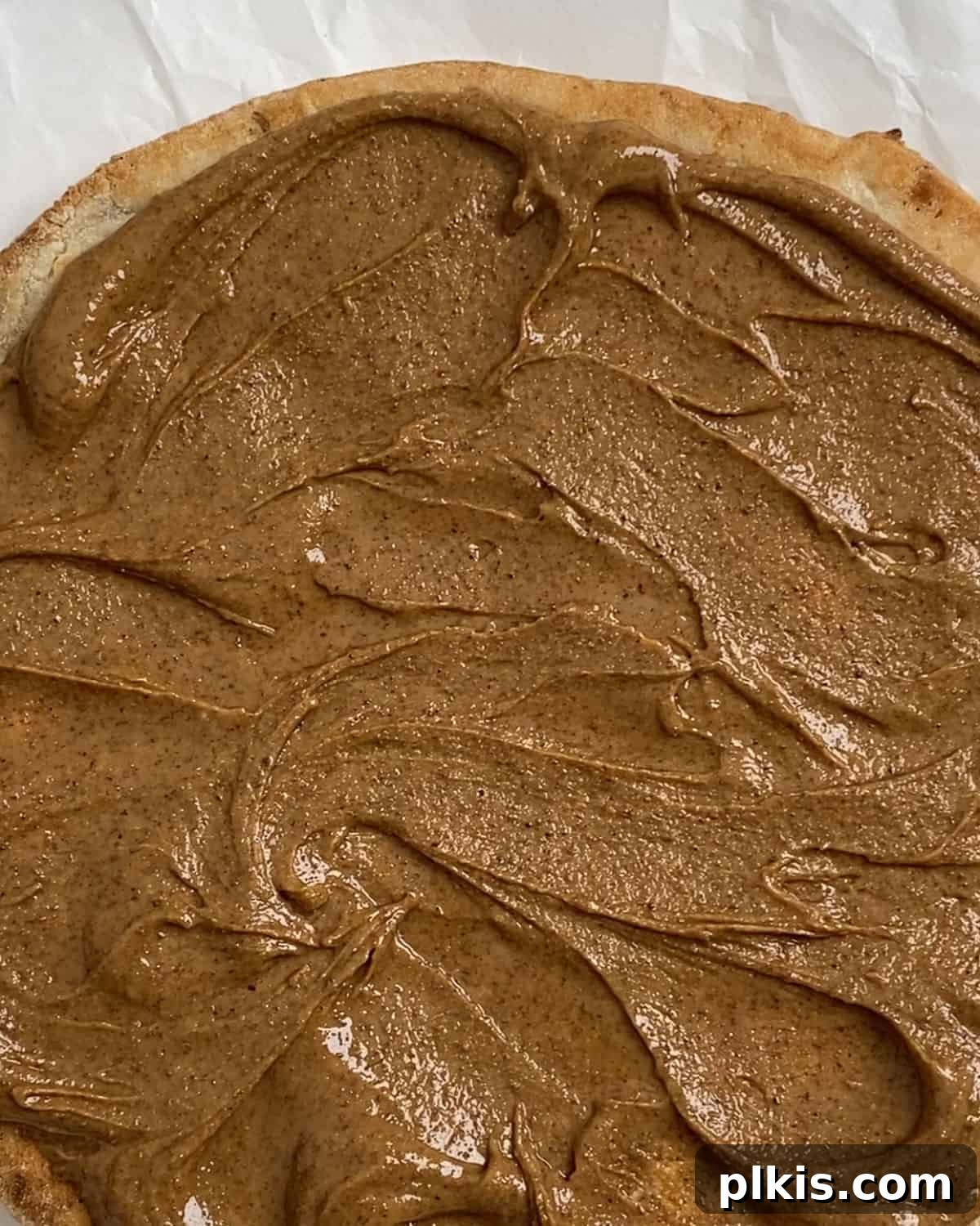 Sunshine Fruit Pizza 5 process of spreading nut butter on cauliflower crust