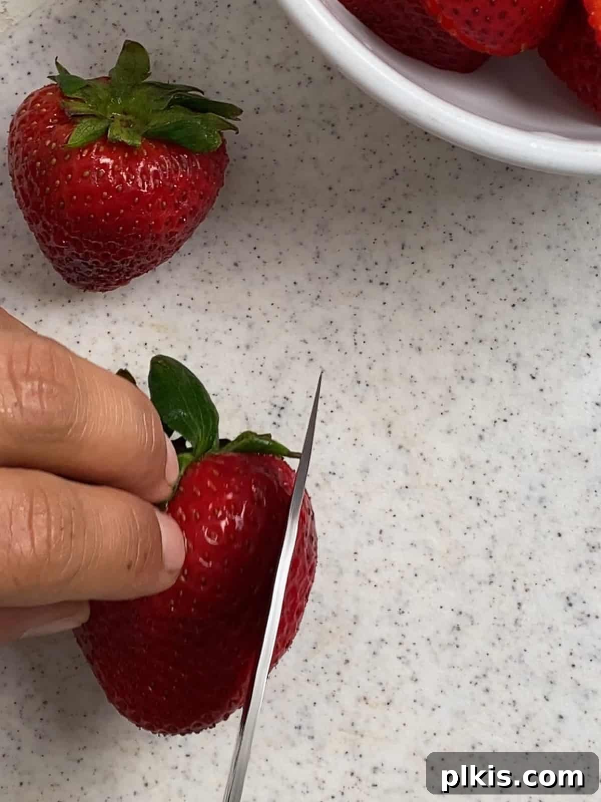 Sunshine Fruit Pizza 6 process of cutting strawbberries