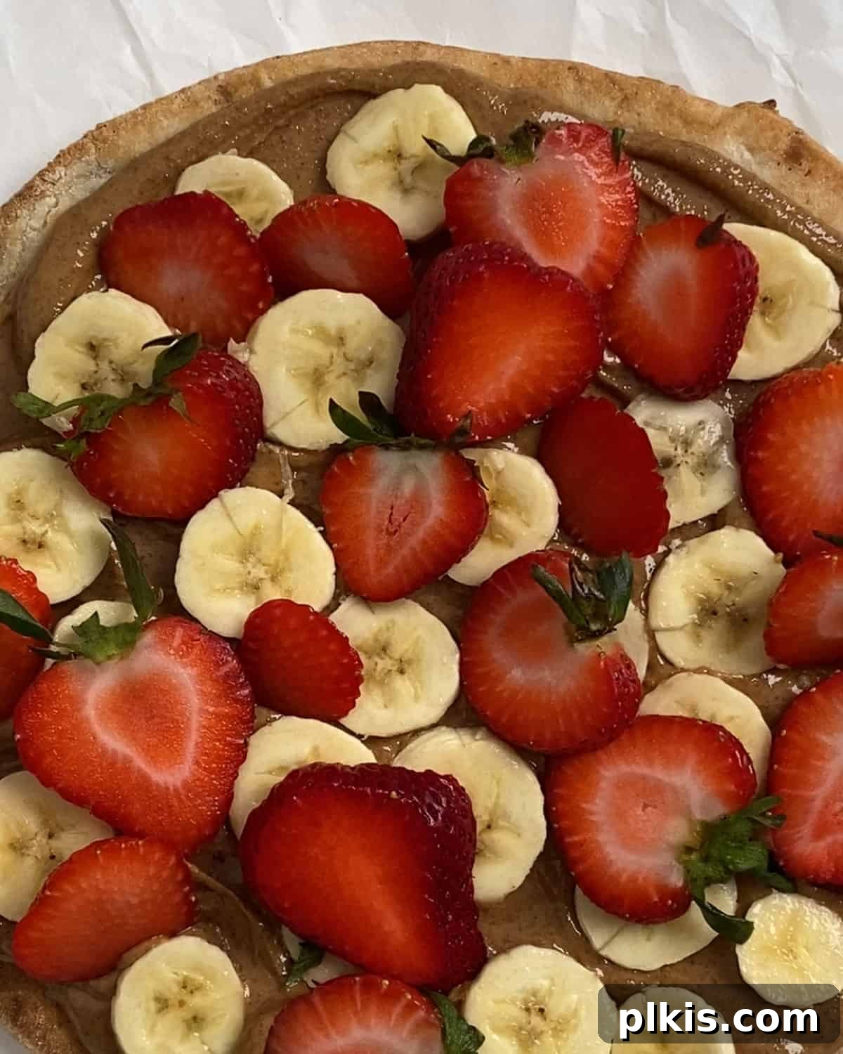 Sunshine Fruit Pizza 9 process of adding strawberries to fruit pizza
