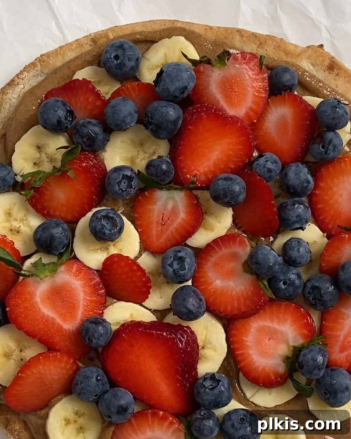 Sunshine Fruit Pizza 10 process of adding blueberries to fruit pizza