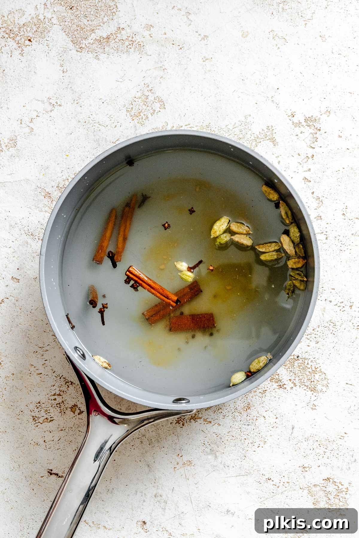 Spiced Chai Concentrate from Scratch 4 Process shot showing ingredients for Homemade Chai Concentrate in a pan.