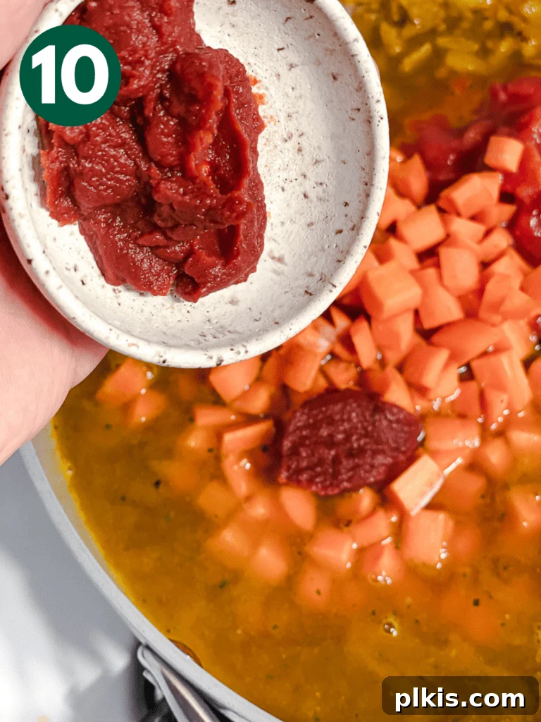 Effortlessly Delicious Curried Lentils 13 Process shot of adding tomato paste to the curried lentils