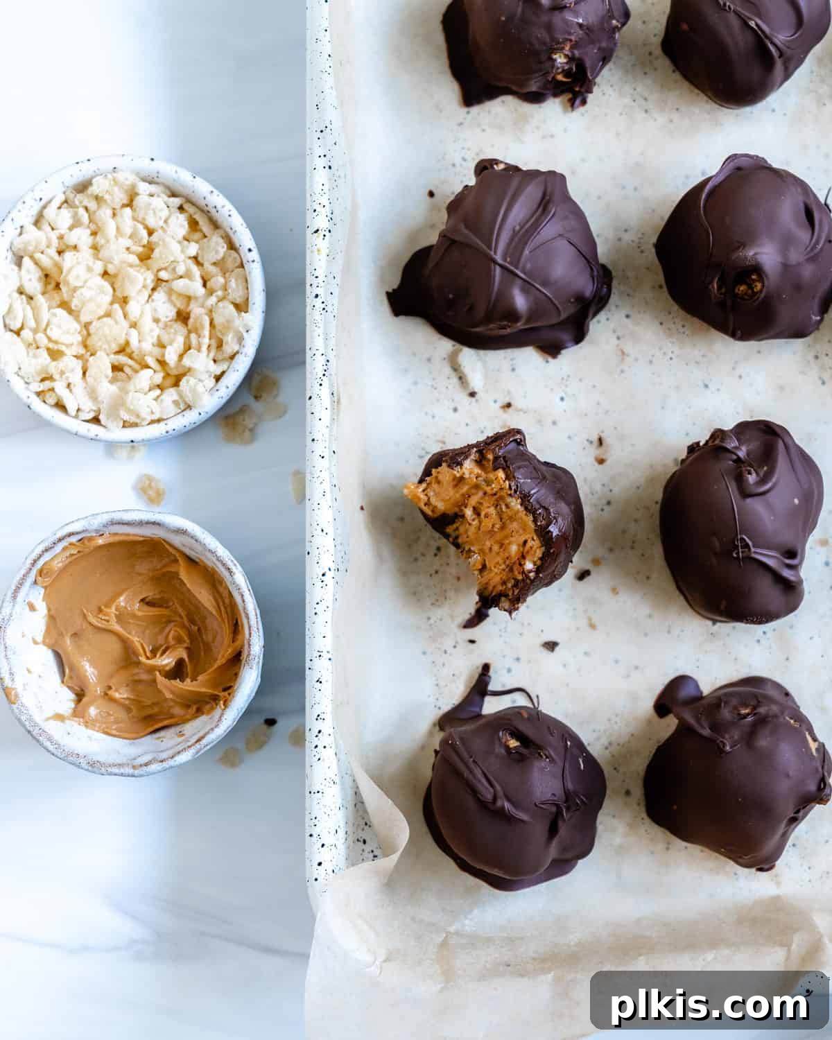 Crispy Vegan No-Bake Chocolate Peanut Butter Bites 2 several completed Peanut Butter Bon Bons with one with a bite taken out of it