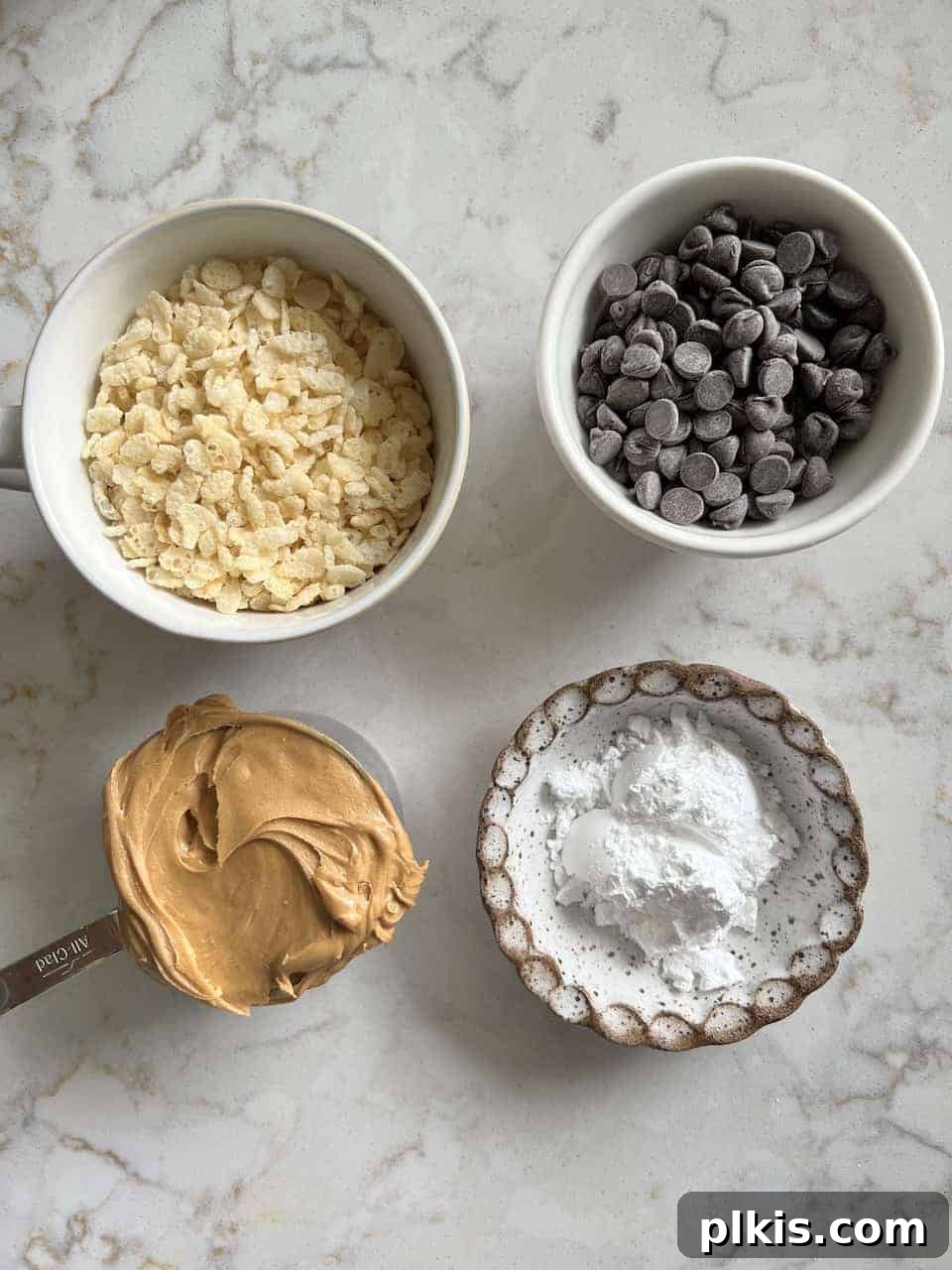 Crispy Vegan No-Bake Chocolate Peanut Butter Bites 3 ingredients for Peanut Butter Bon Bons on a marble white surface