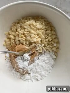 Crispy Vegan No-Bake Chocolate Peanut Butter Bites 4 process of mixing ingredients for Peanut Butter Bon Bons together in a bowl