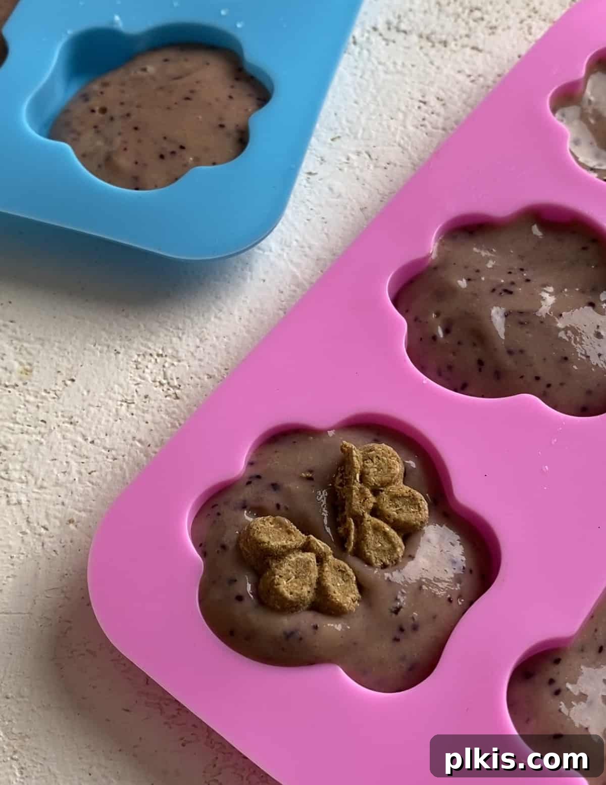 Frosty Peanut Butter Banana Puppy Snacks 11 Pressing halved Fruitables treats into the filled dog treat molds