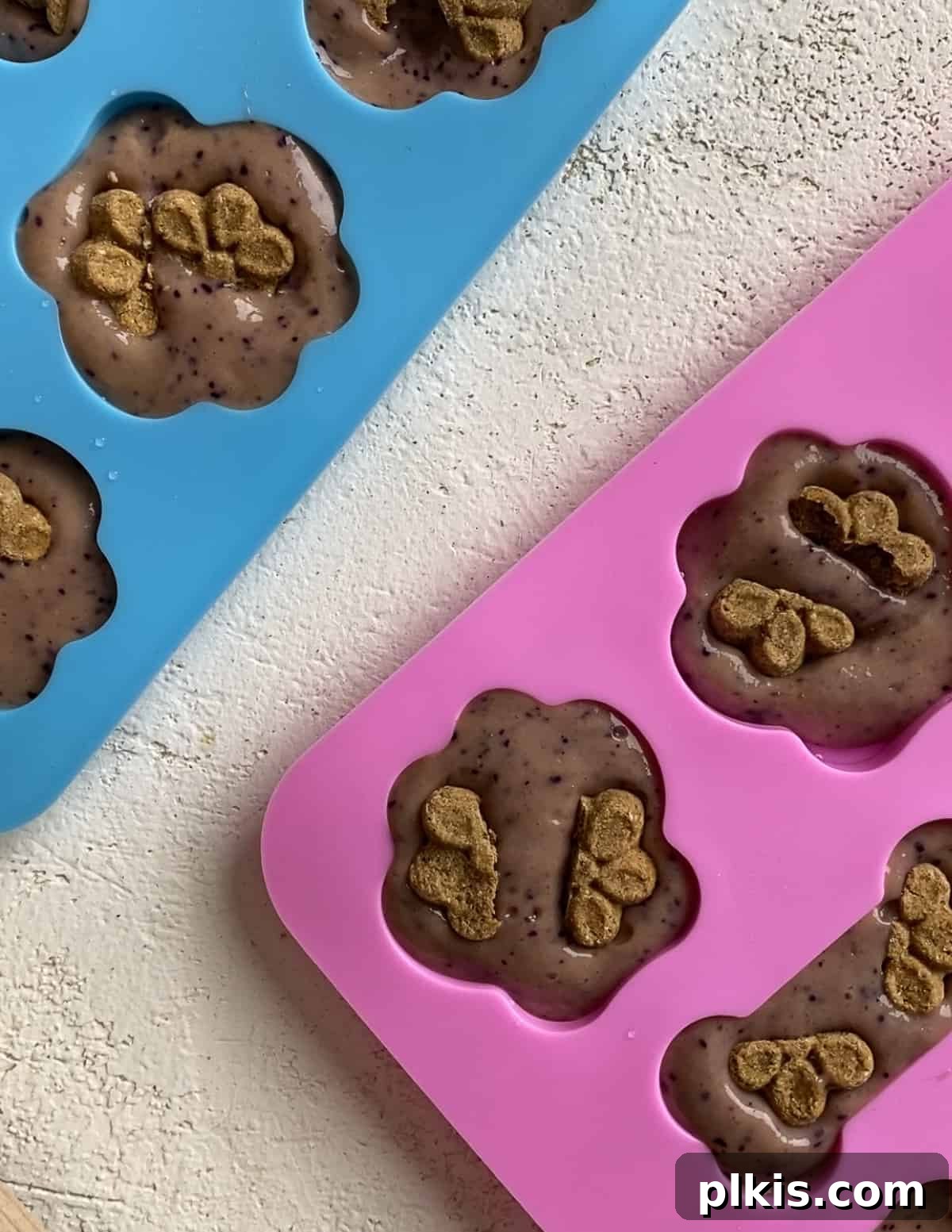 Frosty Peanut Butter Banana Puppy Snacks 12 Close-up of dog treat molds with mixture and Fruitables treats ready for freezing
