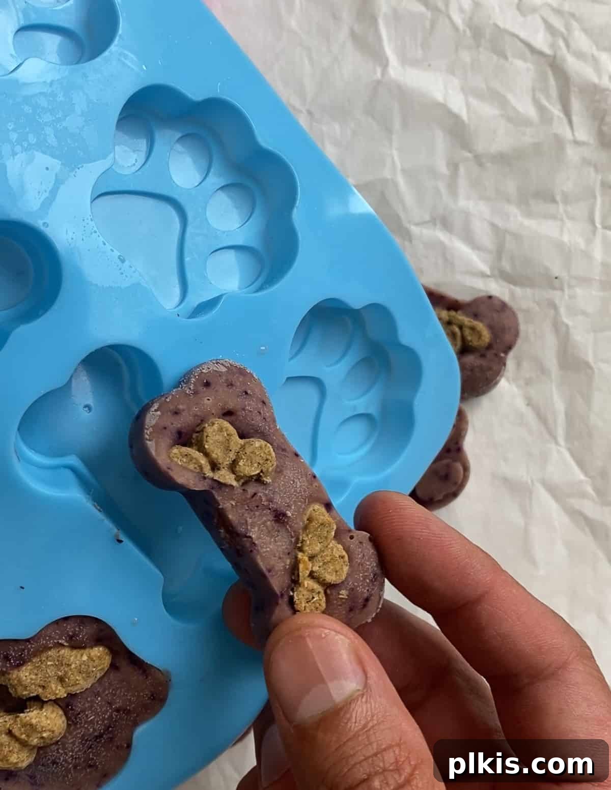 Frosty Peanut Butter Banana Puppy Snacks 13 Removing frozen peanut butter banana dog treats from silicone molds
