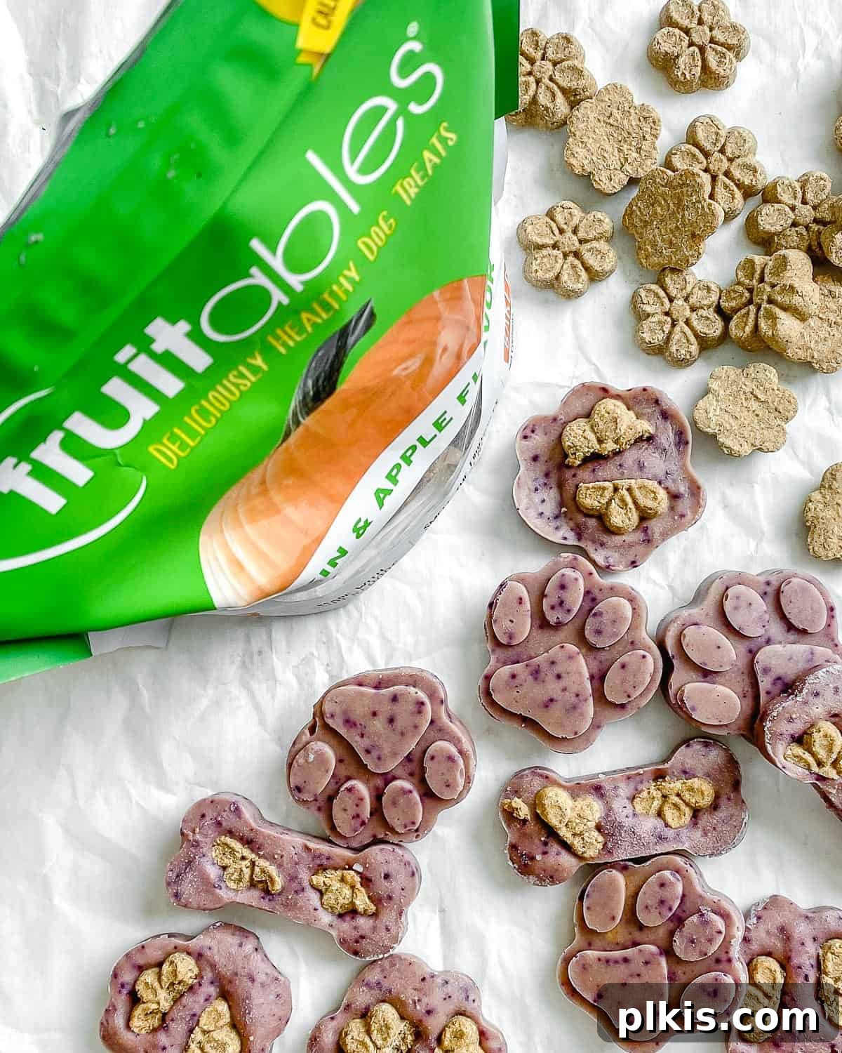Frosty Peanut Butter Banana Puppy Snacks 15 Completed Frozen Peanut Butter Banana Dog Treats in a bowl with Fruitables packaging in the background, ready for happy pups