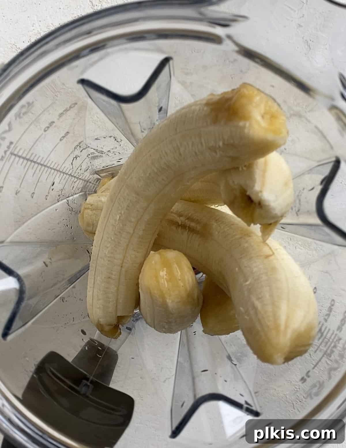 Frosty Peanut Butter Banana Puppy Snacks 5 Adding ripe bananas into a blender for the dog treat mixture