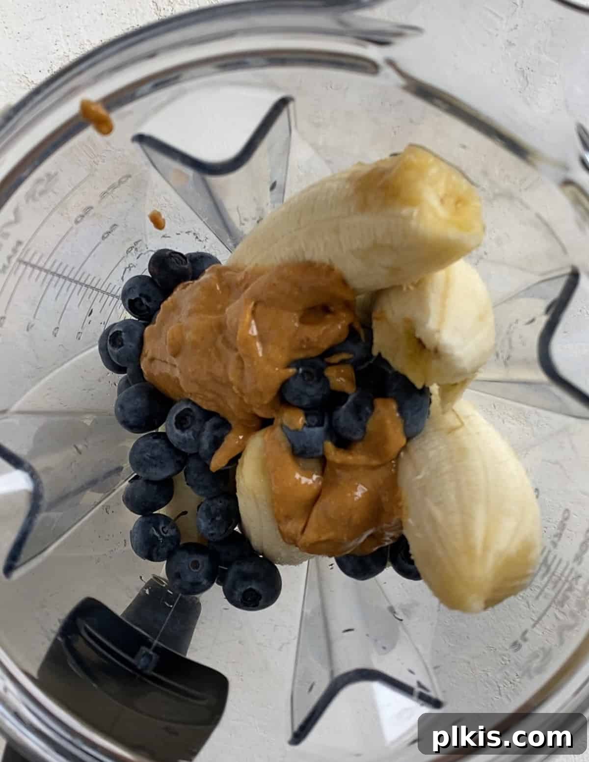 Frosty Peanut Butter Banana Puppy Snacks 7 Adding natural peanut butter to the blender to create the dog treat base