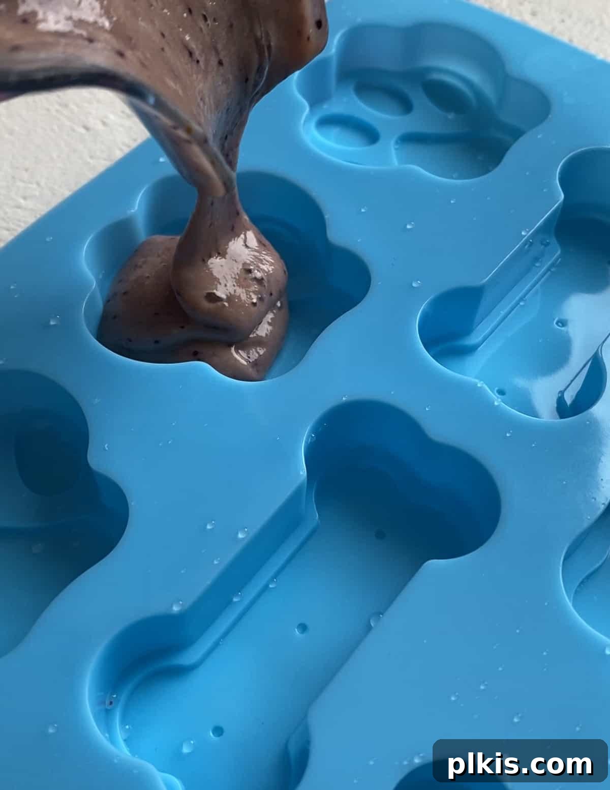 Frosty Peanut Butter Banana Puppy Snacks 8 Pouring the blended peanut butter banana mixture into silicone dog treat molds