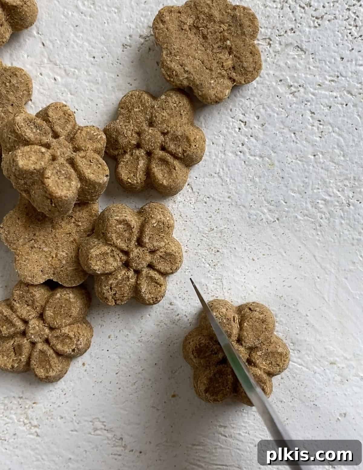 Frosty Peanut Butter Banana Puppy Snacks 10 Cutting Fruitables baked dog treats in half to fit into the molds