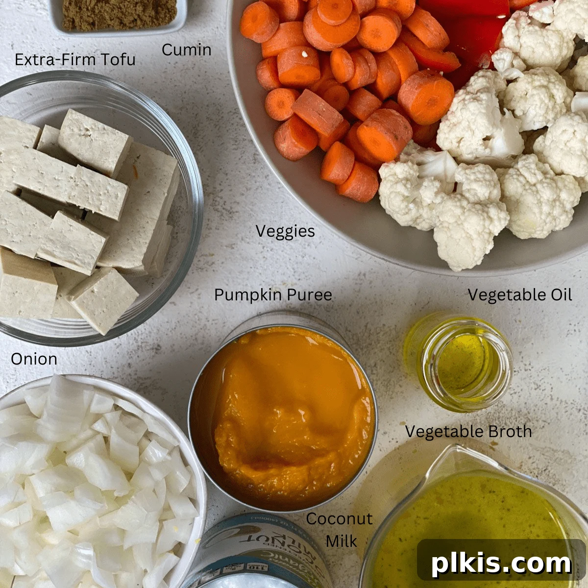 Golden Pumpkin Curry 3 A curated display of all the measured ingredients for pumpkin curry laid out against a clean white surface, showcasing their fresh appeal.