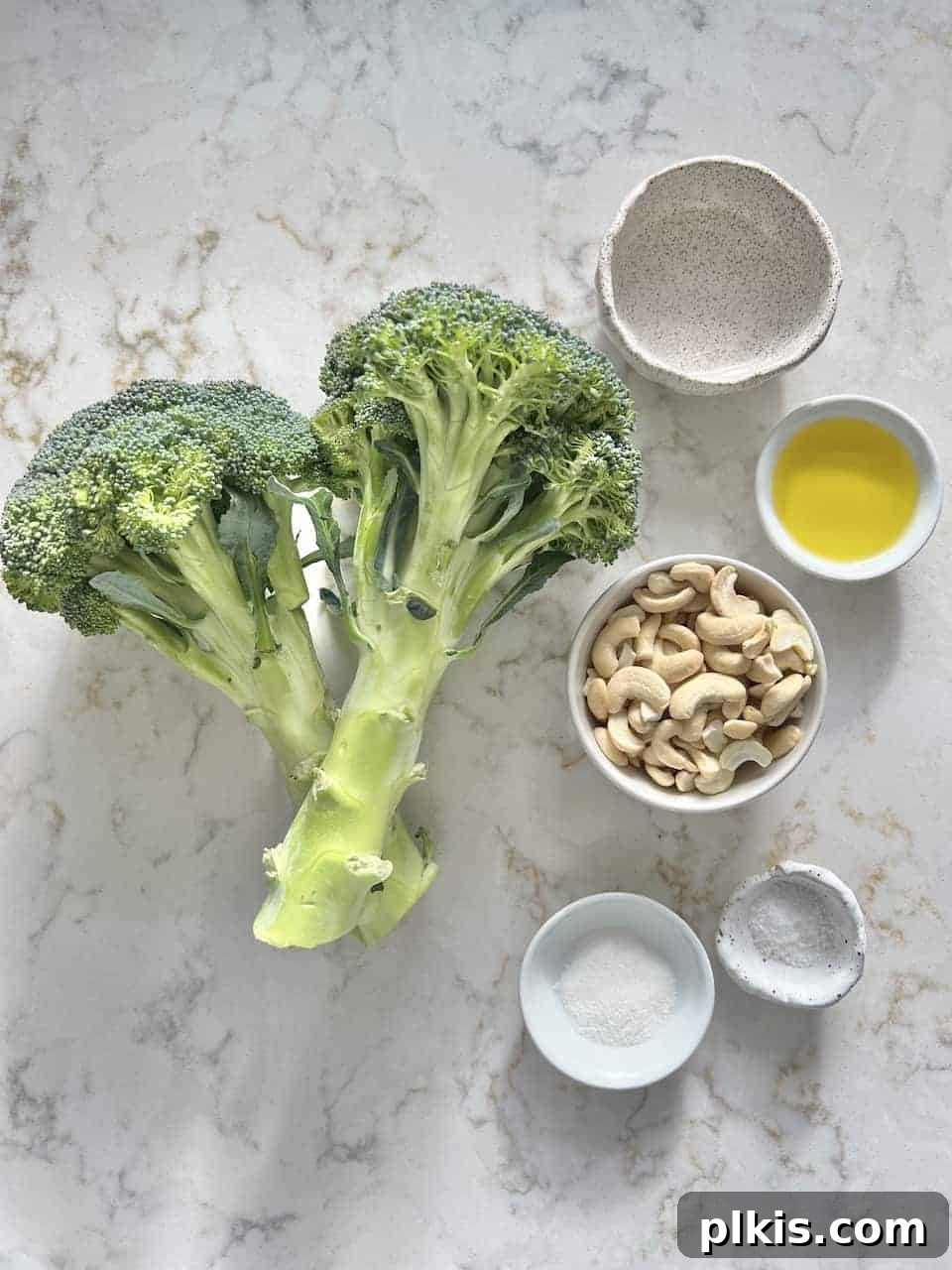 Golden Curry Roasted Broccoli 3 ingredients for Roasted Curried Broccoli measured out against a white surface