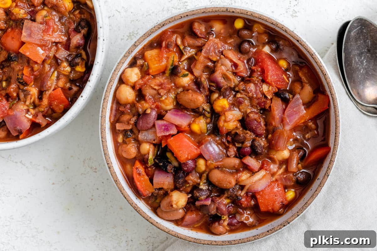 The Ultimate Vegan Bean Chili stovetop Slow Cooker Instant Pot 11 Another enticing shot of the completed Vegan Bean Chili, artfully presented in a bowl, highlighting its rich texture and appealing colors.