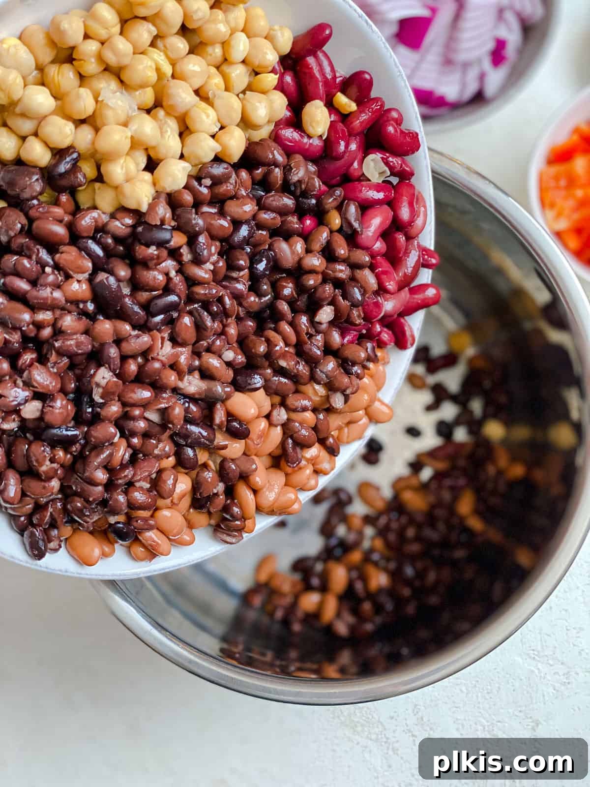 The Ultimate Vegan Bean Chili stovetop Slow Cooker Instant Pot 5 Close-up process shot of pouring diced tomatoes into a slow cooker pot filled with other chili ingredients.
