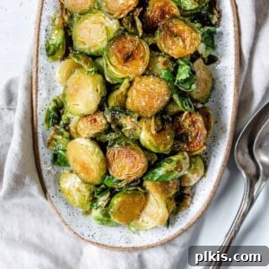 Completed Sweet and Salty Brussels Sprouts in a white dish against a white background