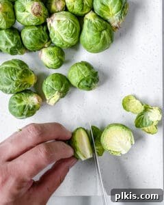 A step-by-step process of preparing Brussels sprouts, showing rinsing, trimming, and halving.