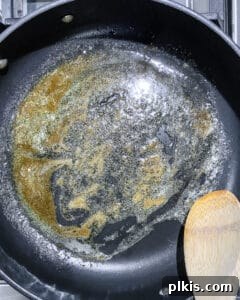 Fully melted vegan butter and brown sugar mixture creating a glaze in the pan.