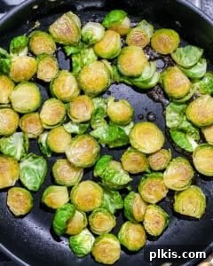 Brussels sprouts caramelizing and turning golden brown in the pan.