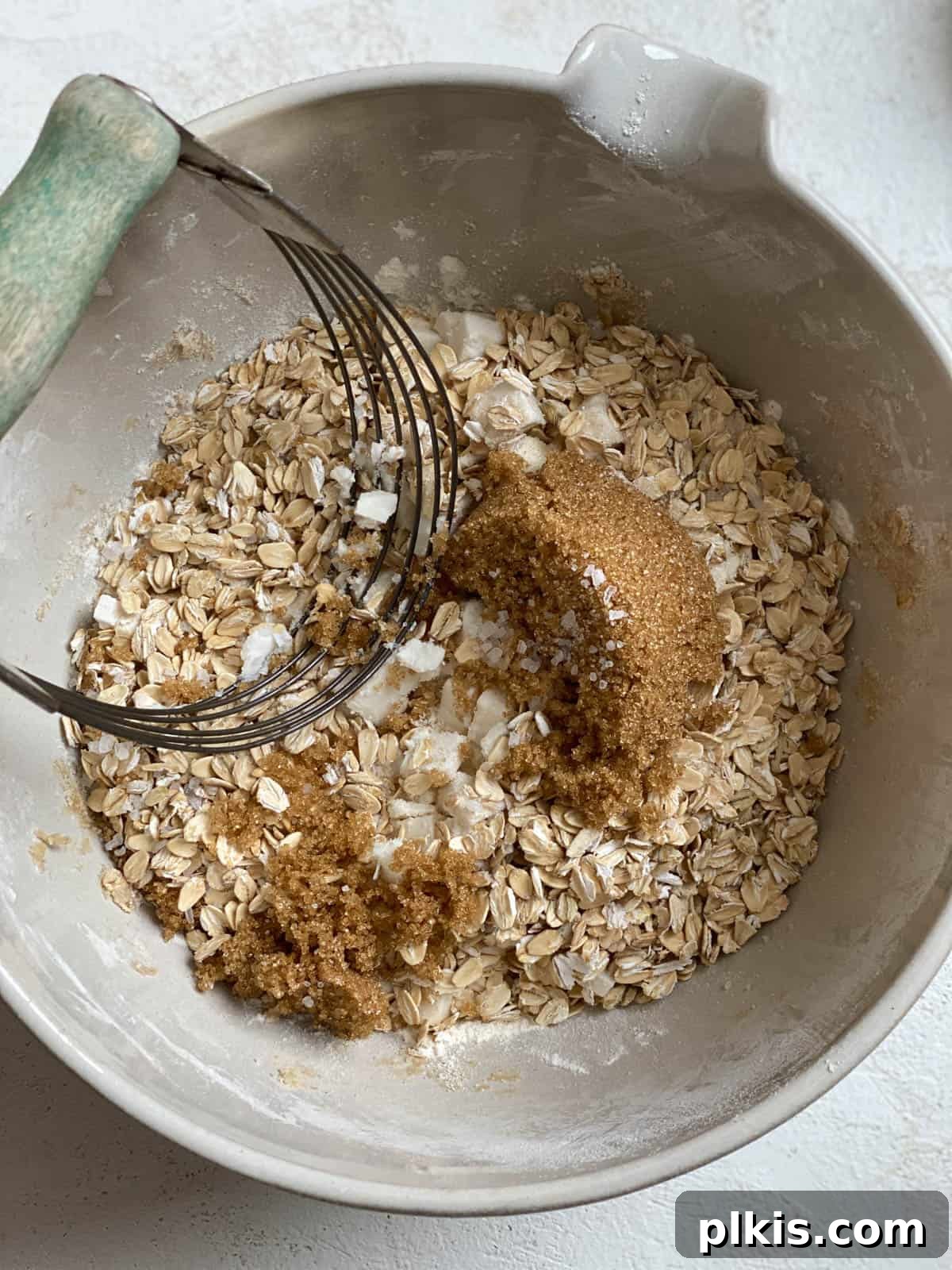 Autumn Apple Cranberry Delight 5 Process shot of mixing brown sugar, flour, and cold vegan butter together in a bowl, forming coarse crumbs for the crisp topping.