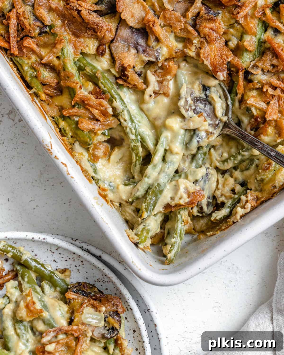 Plant-Powered Green Bean Casserole 9 The finished Dairy-Free Green Bean Casserole presented in a classic white baking dish, ready to be served as a centerpiece for any holiday meal.