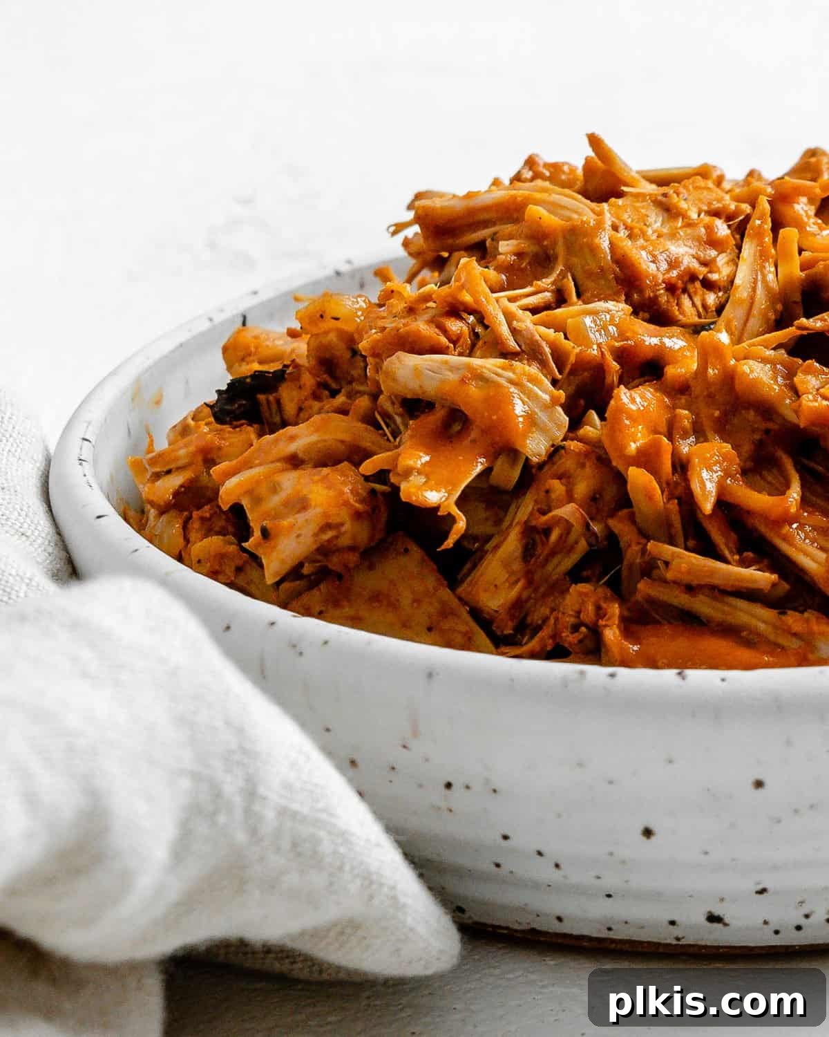 Smoky Vegan Jackfruit BBQ 15 completed vegan bbq jackfruit in a white bowl alongside white towel