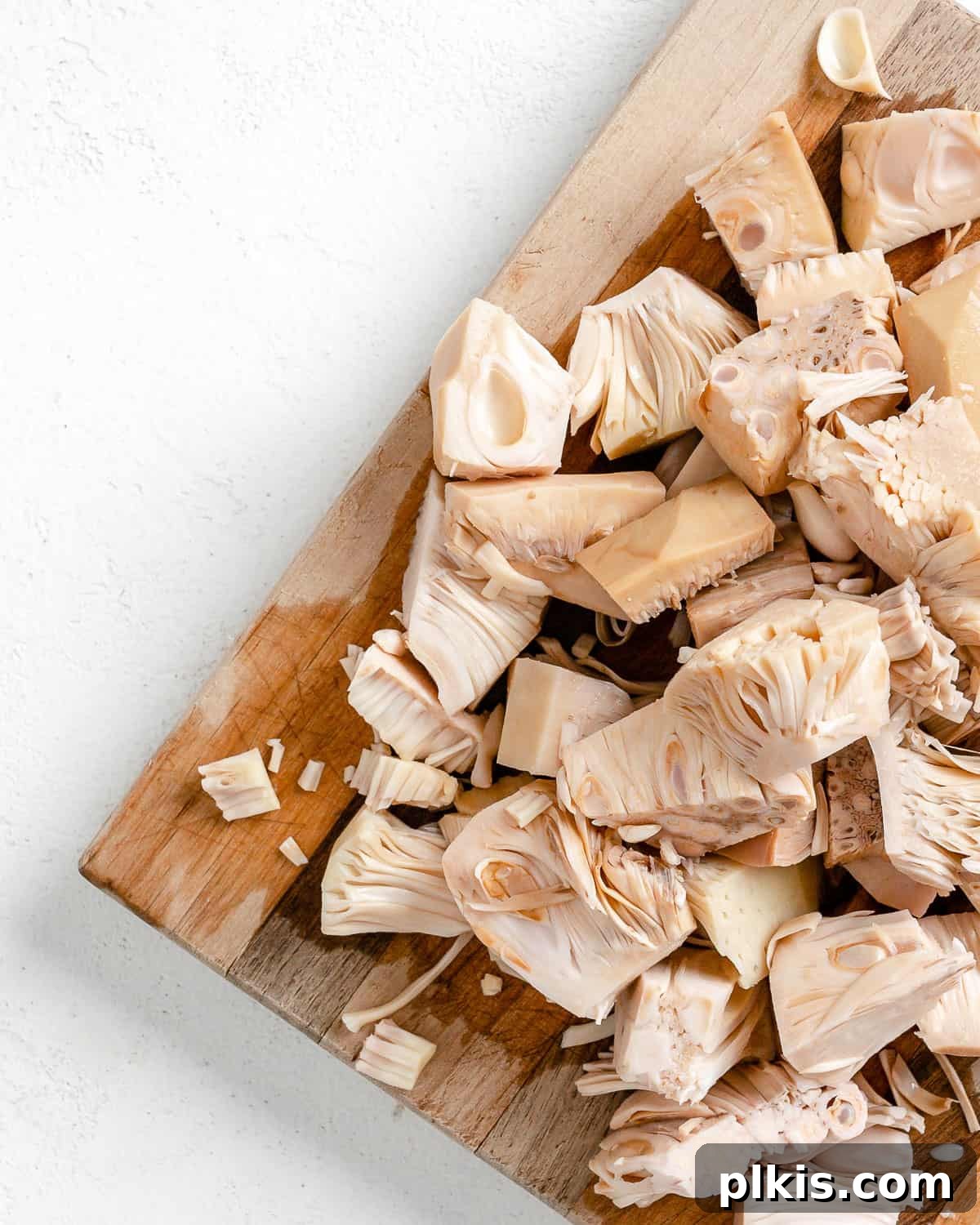 Smoky Vegan Jackfruit BBQ 5 sliced jackfruit on a cutting board against a white surface