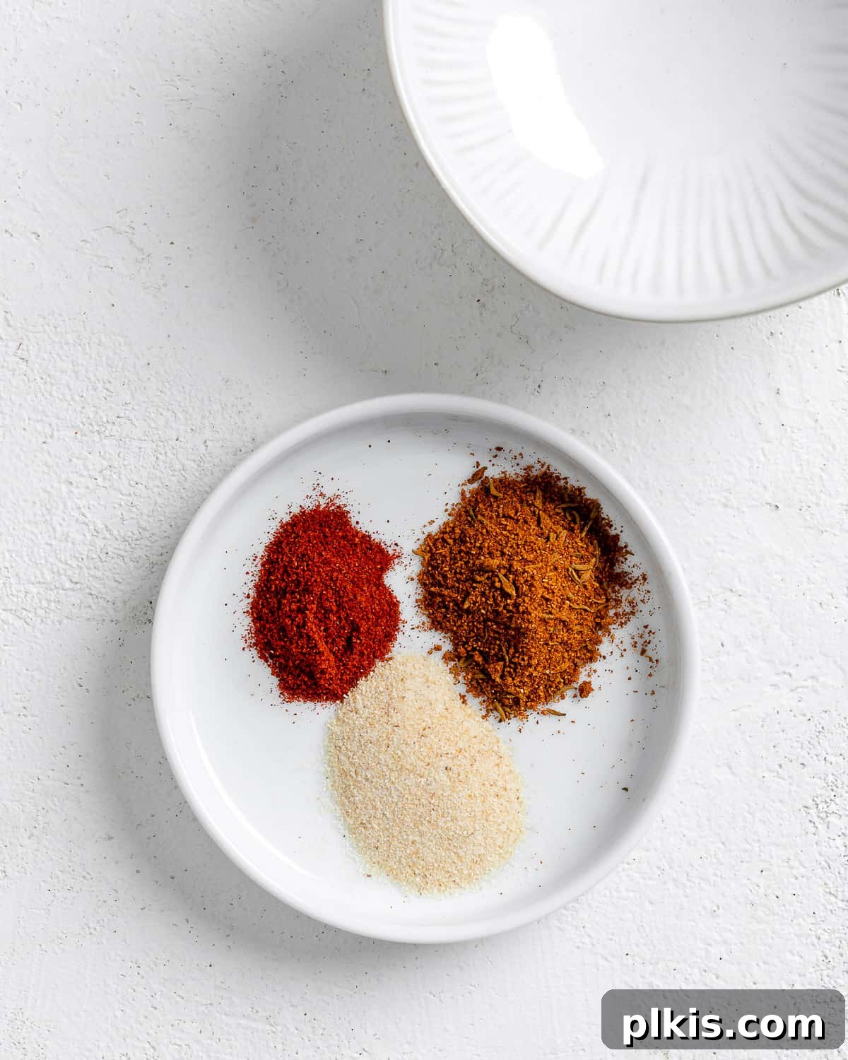 Smoky Vegan Jackfruit BBQ 6 measured out spices in a white dish against a white background