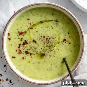 Velvety Vegan Zucchini Soup 2 a bowl of vegan zucchini soup in a white bowl.