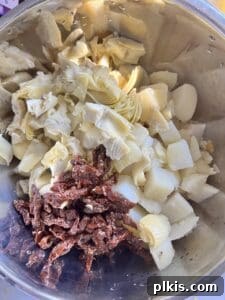 Ingredients for Artichoke Potato Salad with Lemon Dressing laid out in a bowl before tossing.