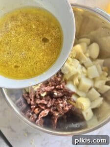 Process of adding lemon dressing to ingredients in a large bowl.