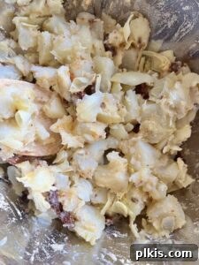 Zesty Artichoke and Potato Salad 8 A combination of the dressing and Artichoke Potato Salad with Lemon Dressing ingredients in bowl, freshly tossed.