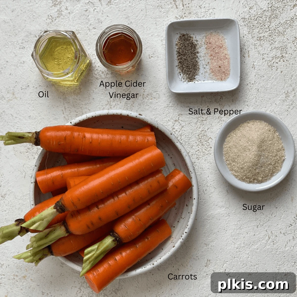 Mastering Glazed Carrots and Their Delicious Flavor Variations 3 A selection of fresh ingredients for glazed carrots, including whole carrots, a bowl of sugar, a bottle of vinegar, and a small container of oil, arranged neatly on a white surface.