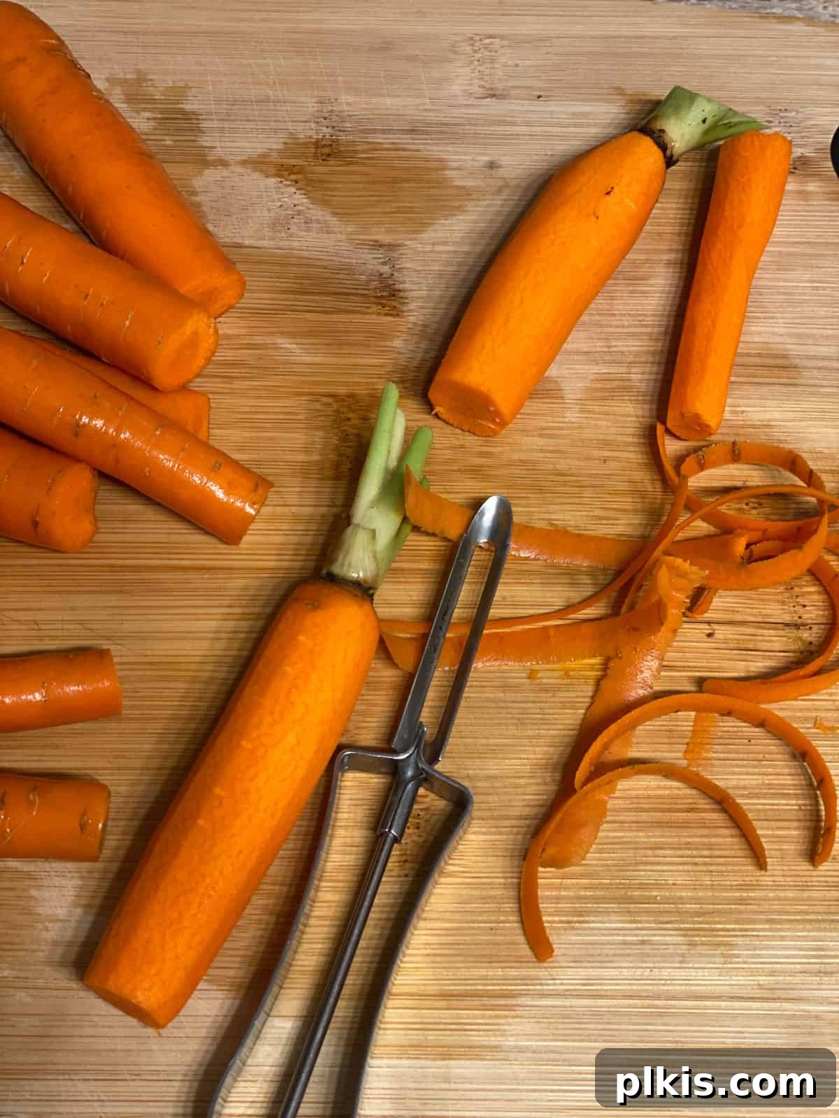 Mastering Glazed Carrots and Their Delicious Flavor Variations 4 A close-up shot of hands peeling fresh carrots on a wooden cutting board, preparing them for cooking.