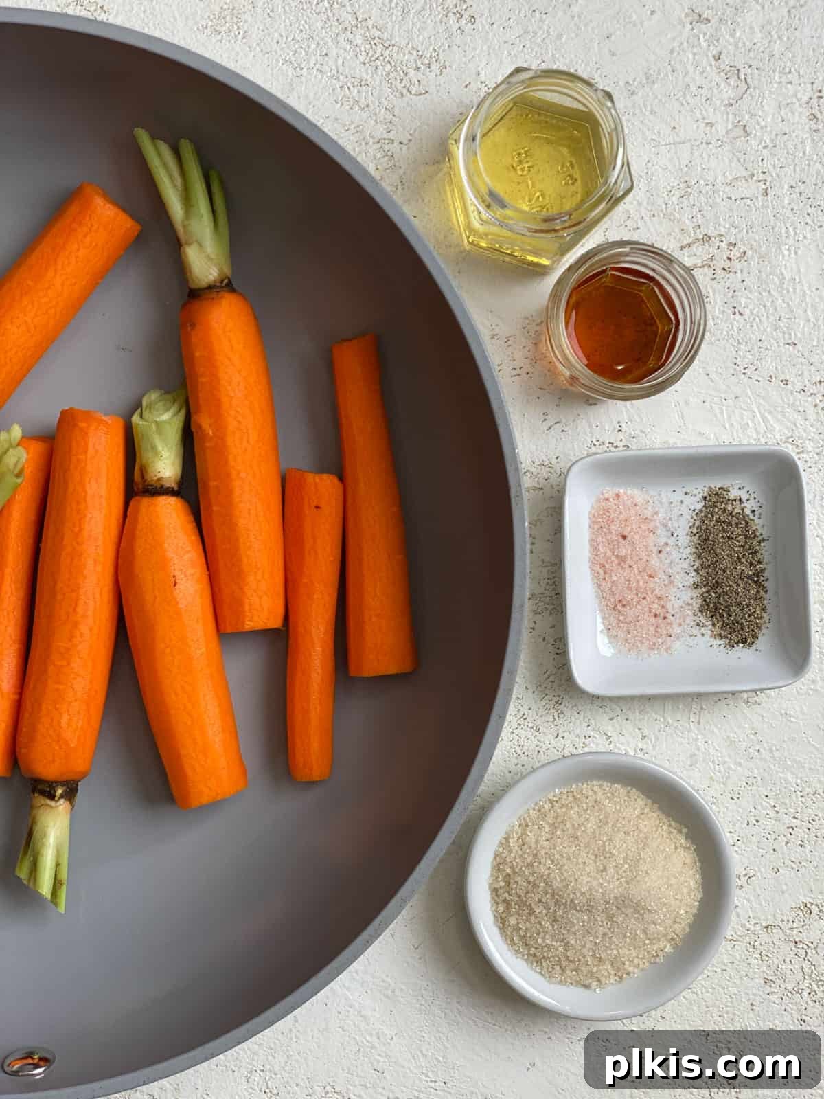 Mastering Glazed Carrots and Their Delicious Flavor Variations 6 Another process shot of carrots simmering in a pan, with the glaze bubbling gently, indicating the start of the cooking process.