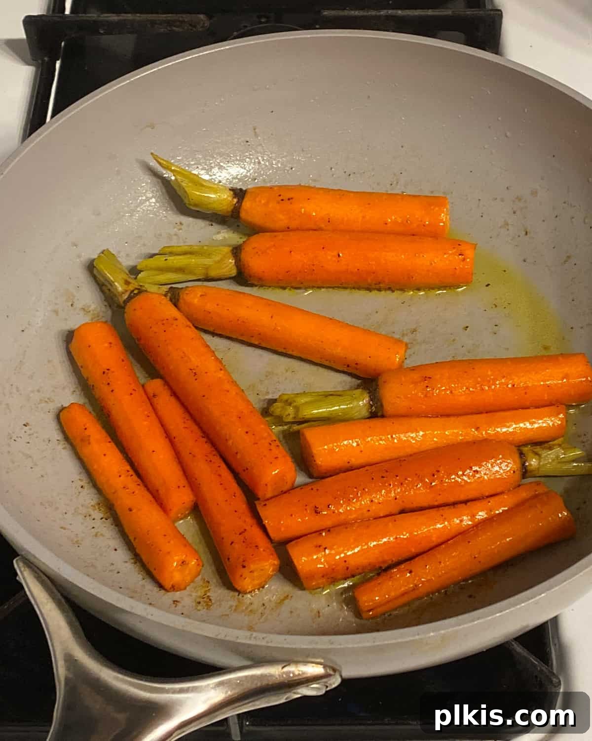 Mastering Glazed Carrots and Their Delicious Flavor Variations 8 Final process shot of glazed carrots in a skillet, showing the liquid nearly evaporated and the carrots tender and caramelized, ready to be served.