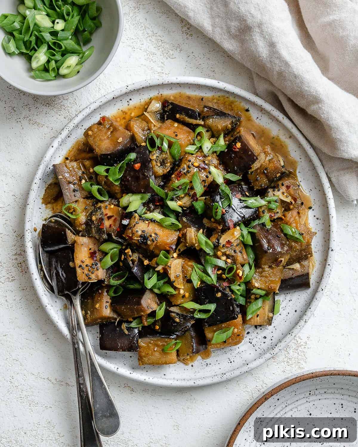 Golden Sautéed Eggplant with Maple Soy Glaze 2 Completed Perfect Sautéed Eggplant plated on a plate against a white background