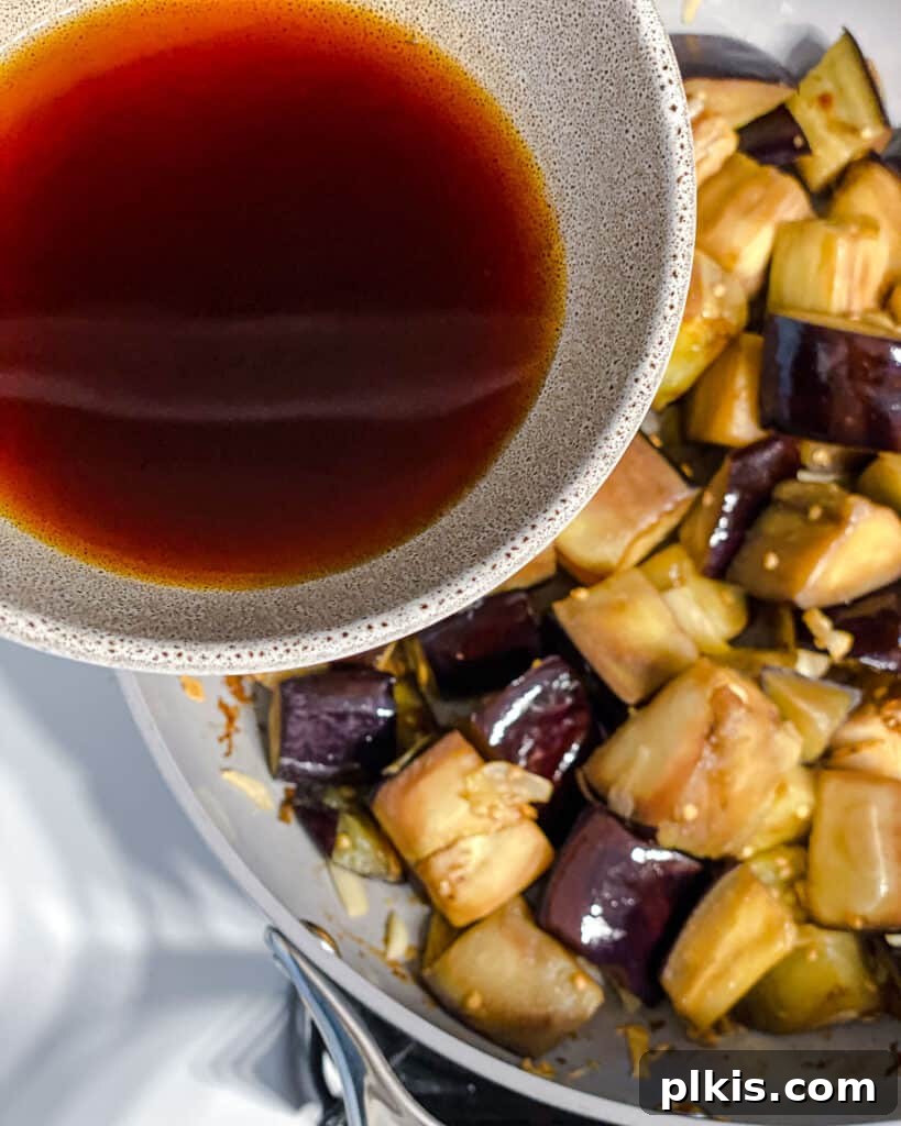 Golden Sautéed Eggplant with Maple Soy Glaze 12 Process shot of adding sauce to pan