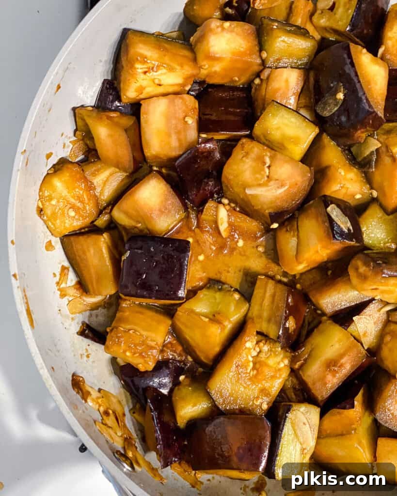 Golden Sautéed Eggplant with Maple Soy Glaze 13 Process shot of mixing sauce with eggplant in pan