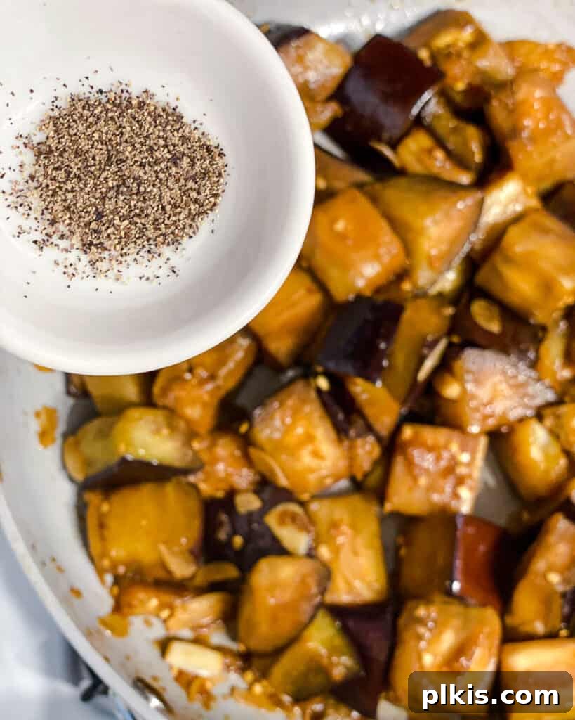 Golden Sautéed Eggplant with Maple Soy Glaze 14 Process shot of adding spices to pan