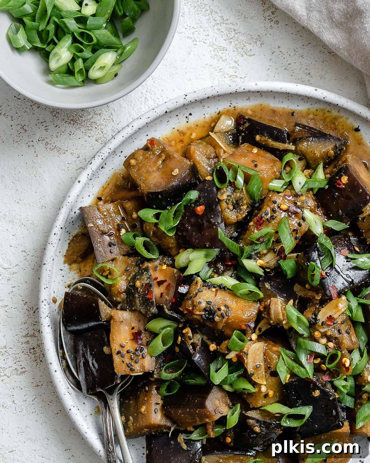 Golden Sautéed Eggplant with Maple Soy Glaze 15 Completed Perfect Sautéed Eggplant plated on a plate against a white background
