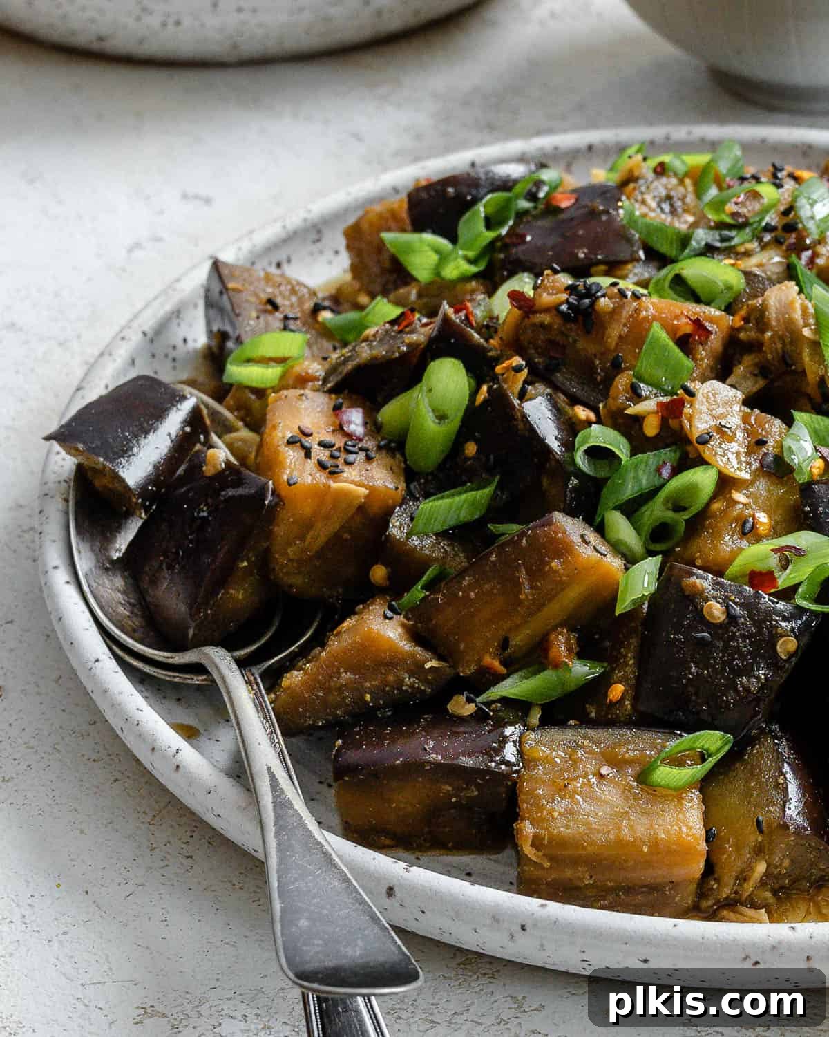 Golden Sautéed Eggplant with Maple Soy Glaze 16 Completed Perfect Sautéed Eggplant plated on a plate against a white background