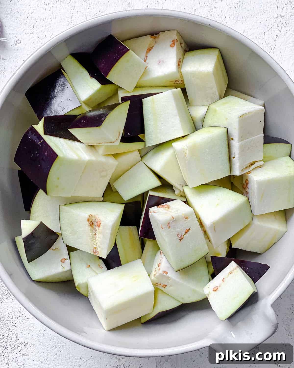 Golden Sautéed Eggplant with Maple Soy Glaze 4 Chopped eggplant in a white bowl