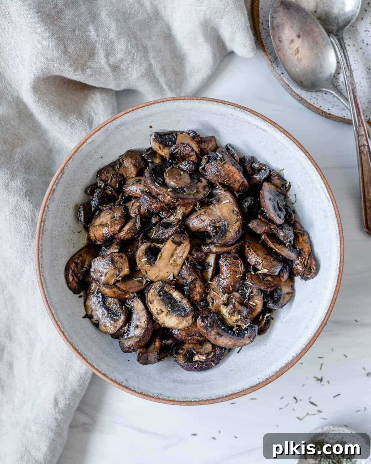 perfectly roasted mushrooms served on a white plate