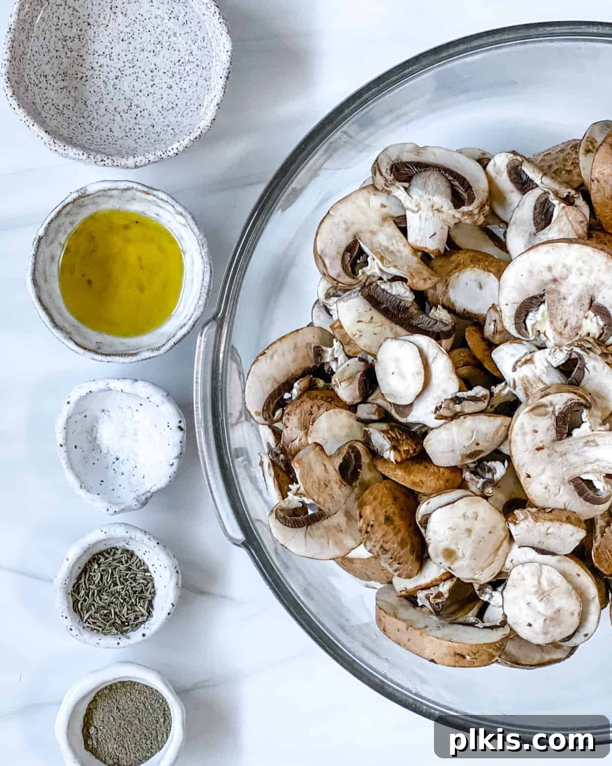 ingredients for simple roasted mushrooms laid out on a surface